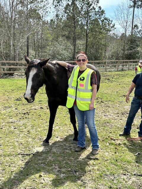 women next to horse