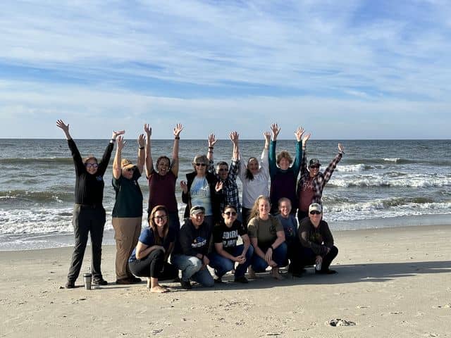 women's retreat group picture on beach